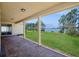 A covered outdoor patio offering stunning lake views and a brick-paved floor for relaxed outdoor living at 15698 Marina Bay Dr, Winter Garden, FL 34787
