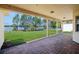 Brick-paved covered patio area that overlooks a green lawn extending to a tranquil lake at 15698 Marina Bay Dr, Winter Garden, FL 34787