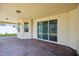 Covered patio with brick pavers and views of the backyard and lake at 15698 Marina Bay Dr, Winter Garden, FL 34787