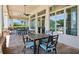 Outdoor patio with dark metal table and chairs, ceiling fans, and view of the pool at 15698 Marina Bay Dr, Winter Garden, FL 34787