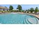 Community pool with lounging area and umbrellas at 15698 Marina Bay Dr, Winter Garden, FL 34787