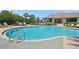Large outdoor community pool with lounge chairs and shaded seating area for residents' enjoyment at 15698 Marina Bay Dr, Winter Garden, FL 34787