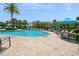Community pool with ample seating and palm trees at 15698 Marina Bay Dr, Winter Garden, FL 34787