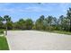 Outdoor sand volleyball court surrounded by palm trees and lush landscaping at 15698 Marina Bay Dr, Winter Garden, FL 34787