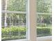 Windows with blinds allowing a view of the greenery outside at 15698 Marina Bay Dr, Winter Garden, FL 34787