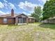 View of the home's backyard with a screened in patio and wooden fence at 1606 Bismarck Dr, Deltona, FL 32725