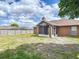 View of the backyard with a screened in patio and wooden fence at 1606 Bismarck Dr, Deltona, FL 32725