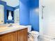 Bathroom features a walk-in shower, vanity with countertop, and blue walls, providing a clean and vibrant space at 1606 Bismarck Dr, Deltona, FL 32725