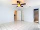 Spacious bedroom features tile flooring, a ceiling fan, and neutral paint, offering a bright and airy feel at 1606 Bismarck Dr, Deltona, FL 32725