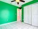 A green bedroom with a closet and a window at 1606 Bismarck Dr, Deltona, FL 32725
