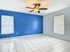 Bedroom with blue accent wall and two windows providing lots of natural light at 1606 Bismarck Dr, Deltona, FL 32725