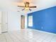 A spacious bedroom with tile flooring, a blue accent wall, and a closet at 1606 Bismarck Dr, Deltona, FL 32725