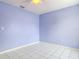 Empty bedroom with light blue walls and tile floors. Ready for your personal touch at 1606 Bismarck Dr, Deltona, FL 32725