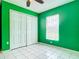 A green bedroom with a closet and a window letting in natural light at 1606 Bismarck Dr, Deltona, FL 32725