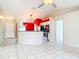 Open-concept kitchen with tile floors, a breakfast bar, and stainless steel appliances at 1606 Bismarck Dr, Deltona, FL 32725