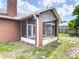 Enclosed back patio features a screen enclosure, access to the backyard, and ample space for outdoor seating at 1606 Bismarck Dr, Deltona, FL 32725