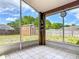 Screened lanai with view of fenced yard, offering a peaceful outdoor retreat with a shed and lush greenery at 1606 Bismarck Dr, Deltona, FL 32725
