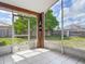 Enclosed lanai with sliding screen doors, offers outdoor views, and decorative shelving at 1606 Bismarck Dr, Deltona, FL 32725