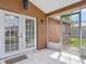 Covered lanai features tile flooring, screen enclosure, and yard access, perfect for relaxation and entertaining at 1606 Bismarck Dr, Deltona, FL 32725