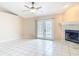 Bright living room featuring tile floors, a fireplace, and double doors to the backyard at 1606 Bismarck Dr, Deltona, FL 32725