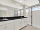 Modern bathroom with white cabinets, a black countertop, and a glass-enclosed shower at 16217 Prairie School Dr, Winter Garden, FL 34787