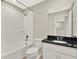 Clean bathroom featuring a combined tub and shower, toilet, vanity and solid surface countertop at 16217 Prairie School Dr, Winter Garden, FL 34787