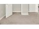 Carpeted flooring of a large bedroom space with three open doorways at 16217 Prairie School Dr, Winter Garden, FL 34787