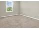 Bright bedroom featuring a window and neutral carpeting and paint at 16217 Prairie School Dr, Winter Garden, FL 34787