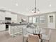 Open concept kitchen and living area, complete with sleek countertops and a dining area at 16217 Prairie School Dr, Winter Garden, FL 34787