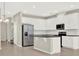 Modern kitchen features stainless steel appliances, white cabinetry, and a spacious island at 16217 Prairie School Dr, Winter Garden, FL 34787