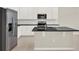This kitchen showcases white cabinetry, stainless steel appliances, and a center island at 16217 Prairie School Dr, Winter Garden, FL 34787