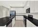 Modern kitchen boasts stainless steel appliances, granite countertops, and white cabinets at 16217 Prairie School Dr, Winter Garden, FL 34787
