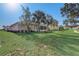 Lush backyard featuring a well-maintained lawn and mature shade trees at 1900 Nw 57Th Ct, Ocala, FL 34482