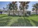 Rear exterior shot showcasing spacious yard with mature landscaping at 1900 Nw 57Th Ct, Ocala, FL 34482
