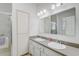 Bright bathroom with double sinks, a large mirror, and a shower, designed for convenience at 1900 Nw 57Th Ct, Ocala, FL 34482
