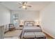 Cozy bedroom with neutral tones, featuring a ceiling fan, plush bedding, and a window for natural light at 1900 Nw 57Th Ct, Ocala, FL 34482
