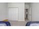 Bright bedroom featuring a closet and neutral carpeting throughout at 1900 Nw 57Th Ct, Ocala, FL 34482