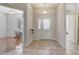 Inviting foyer with decorative glass front door and tile flooring, adjacent to a living area at 1900 Nw 57Th Ct, Ocala, FL 34482