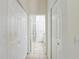 Hallway with tile flooring and multiple closet doors, providing ample storage space at 1900 Nw 57Th Ct, Ocala, FL 34482