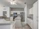 Bright kitchen featuring a tile backsplash, stainless steel appliances, and white cabinets at 1900 Nw 57Th Ct, Ocala, FL 34482