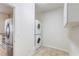 Convenient laundry room with stacked washer and dryer units and cabinet storage at 1900 Nw 57Th Ct, Ocala, FL 34482