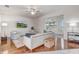 Bright living room boasts hardwood floors, ceiling fan, and sliding glass doors to the lanai at 1900 Nw 57Th Ct, Ocala, FL 34482