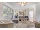 Open concept living room featuring neutral tones, a comfortable couch, and sliding glass doors to a patio at 1900 Nw 57Th Ct, Ocala, FL 34482