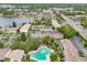 Aerial view of a residential community featuring a pool, lush landscaping, and well-maintained buildings near a lake at 200 Maitland Ave # 52, Altamonte Springs, FL 32701