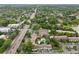 Aerial view of a residential area showcasing well-maintained condo buildings, lush trees, a pool, and nearby lake access at 200 Maitland Ave # 52, Altamonte Springs, FL 32701