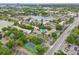 Aerial view of a community near a lake and tennis court, featuring well-maintained buildings, lush landscaping, and parking at 200 Maitland Ave # 52, Altamonte Springs, FL 32701