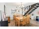 Open dining room features wood-look tile and an open view to the kitchen and stairs at 200 Maitland Ave # 52, Altamonte Springs, FL 32701