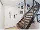 Bright entryway with hardwood floors, decorative accents, and a staircase with dark wood railing at 200 Maitland Ave # 52, Altamonte Springs, FL 32701