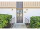 Inviting front door with glass panes, landscaped entrance with manicured hedges, and clear unit number at 200 Maitland Ave # 52, Altamonte Springs, FL 32701