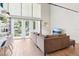 Bright living room with high ceilings, large windows, sliding glass door, and comfortable seating at 200 Maitland Ave # 52, Altamonte Springs, FL 32701